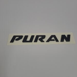 Custom eco dome sticker with glossy black PURAN lettering on a rectangular backing sheet.